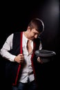 Boy or guy in national ethnic clothing posing in Studio on black background. Young man with hat in dark room Royalty Free Stock Photo