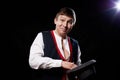 Boy or guy in national ethnic clothing posing in Studio on black background. Young man with hat in dark room Royalty Free Stock Photo