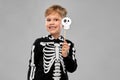 Boy in halloween costume of skeleton making faces Royalty Free Stock Photo