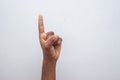 Boy hand showing number one gesture symbol on white background. Gesturing number 1. Number one in sign language. counting