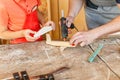 Boy hand works creating wooden airplane toy in the carpentry. Woodwork classes for children and creativity concept