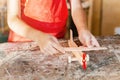 Boy hand works creating wooden airplane toy in the carpentry. Woodwork classes for children and creativity concept