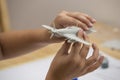 Boy hands assembling plastic model kit of ww2 aircraft