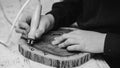 Boy hands burn out numbers with soldering iron on wooden disc. Kid makes wooden clock in the workshop Royalty Free Stock Photo