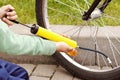 Boy hands pumping bicycle tire in summer Royalty Free Stock Photo