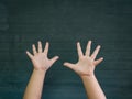 The boy hands raise up on the blackboard background. Happy, Back Royalty Free Stock Photo
