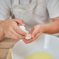 Boy hands separating the egg white from the yolk for the pie Royalty Free Stock Photo