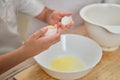 Boy hands separating the egg white from the yolk for the pie Royalty Free Stock Photo