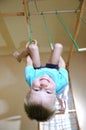 Boy hanging on gymnastic rings Royalty Free Stock Photo