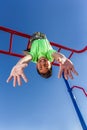 Boy hangs upside down while playing.