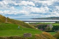 A boy happily playing football near Tynemouth Priory and Castle.