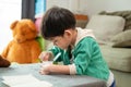 A boy happily uses a spoon to scoop up yogurt