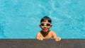 Boy happy swimming in a pool. Beautiful little boy swimming at the pool.