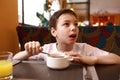 Boy has breakfast in restaurant Royalty Free Stock Photo