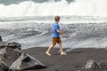 Boy has fun at the black volcanic beach Royalty Free Stock Photo