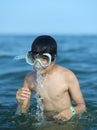 Boy has fun with the diver mask in the sea Royalty Free Stock Photo