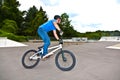 Boy has fun with his BMX at the skatepark Royalty Free Stock Photo