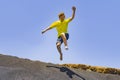 Boy has fun jumping in the dunes of the beach Royalty Free Stock Photo