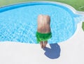 Boy has fun jumping in the outdoor pool Royalty Free Stock Photo