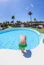 boy has fun jumping in the outdoor pool Royalty Free Stock Photo