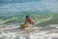 Boy has fun surfing in the waves Royalty Free Stock Photo