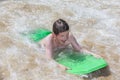 Boy has fun surfing in the waves