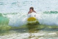 Boy has fun surfing in the waves Royalty Free Stock Photo