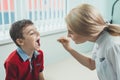 Boy has strep throat. Children`s ENT doctor examines boy`s throat. Children`s diseases, medical examination. medical test in
