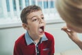 Boy has strep throat. Children`s ENT doctor examines boy`s throat. Children`s diseases, medical examination. medical test in