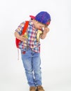 Boy with hat eats fruit in a funny way