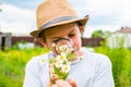 Boy examines through a magnifying glass chamomile