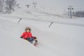 Boy have fun on tubing in the winter. Winter fun for the whole family Royalty Free Stock Photo