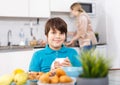 Boy having breakfast at kitchen Royalty Free Stock Photo