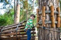 Boy having fun at adventure park. toddler climbing in a rope playground structure. toddler climbing in a rope playground structure