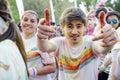 Boy having fun at The Color Run Bucharest showing `come on` sign.