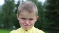 The boy is having fun, first angry, then joyful, laughing. Emotions on the face of the child. Face close-up