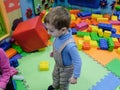 Boy having fun in kids amusement park and indoor play center. Child playing with colorful toys in playground. Royalty Free Stock Photo