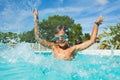 Boy having fun splashing water in swimming pool Royalty Free Stock Photo