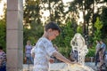 Boy having fun in water fountains. Child playing with a city fountain on hot summer day. Happy kids having fun in fountain. Summer Royalty Free Stock Photo