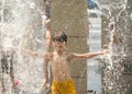 Boy having fun in water fountains. Child playing with a city fountain on hot summer day. Happy kids having fun in fountain. Summer Royalty Free Stock Photo