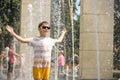 Boy having fun in water fountains. Child playing with a city fountain on hot summer day. Happy kids having fun in fountain. Summer Royalty Free Stock Photo