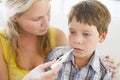 Boy Having His Temperature Measured