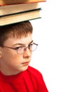 Boy on head with books Royalty Free Stock Photo