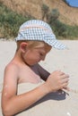 Boy in headdress in the sand Royalty Free Stock Photo