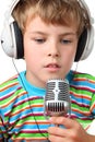 Boy in headphone with microphone in hands opened Royalty Free Stock Photo