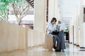 a boy with headphone and veiled girl in high school uniform using a laptop computer together Royalty Free Stock Photo