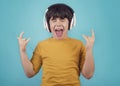 Boy with headphones showing rock sigh