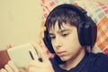 Boy with headphones and smart phone