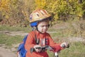 A boy in a helmet with a backpack rides a bicycle. Walk in the park Royalty Free Stock Photo