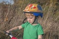 A boy in a helmet with a backpack rides a bicycle. Walk in the park Royalty Free Stock Photo